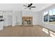 Living room featuring a stone fireplace, hardwood floors, and abundant natural light at 81 Bridgemill Dr, Douglasville, GA 30134