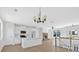 Spacious kitchen opens to the living room with a stone fireplace, ceiling fan, and island at 81 Bridgemill Dr, Douglasville, GA 30134