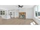 Living room featuring a stone fireplace and large windows for natural light at 81 Bridgemill Dr, Douglasville, GA 30134