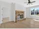Cozy living room with a stone fireplace, hardwood floors, and abundant natural light at 81 Bridgemill Dr, Douglasville, GA 30134