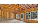 Unfinished room showing wood frame, windows and door to the outside at 81 Bridgemill Dr, Douglasville, GA 30134