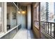 Balcony with city views, concrete column, and glass railings, offering an outdoor living space at 845 Spring St # 125, Atlanta, GA 30308