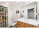 Bright bathroom featuring a shower-tub combination, vanity with modern fixtures and ample lighting at 845 Spring St # 125, Atlanta, GA 30308