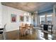 Modern dining room with a wooden table set, concrete ceilings, and large windows for natural light at 845 Spring St # 125, Atlanta, GA 30308