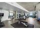 Shared gym with treadmills, weights, mirror, and concrete ceiling with floor to ceiling windows at 845 Spring St # 125, Atlanta, GA 30308