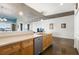 Kitchen with stainless steel dishwasher, wood cabinets, and view into living room with concrete ceilings at 845 Spring St # 125, Atlanta, GA 30308