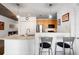 Galley kitchen featuring wood cabinets, stainless steel appliances, and barstool seating at the breakfast bar at 845 Spring St # 125, Atlanta, GA 30308
