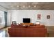 Living room with modern furnishings, a television, a textured sofa and a wall of windows with city views at 845 Spring St # 125, Atlanta, GA 30308