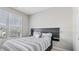 Bedroom with modern headboard featuring a patterned comforter and natural light at 10 Perimeter Summit Ne Blvd # 1204, Brookhaven, GA 30319
