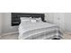 Bedroom features modern headboard and a patterned comforter at 10 Perimeter Summit Ne Blvd # 1204, Brookhaven, GA 30319