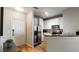 Well-lit kitchen with stainless steel appliances, granite countertops, and direct access to front door at 10 Perimeter Summit Ne Blvd # 1204, Brookhaven, GA 30319