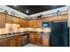 Kitchenette with wood cabinets, granite counters and stainless steel appliances at 10 Perimeter Summit Ne Blvd # 1204, Brookhaven, GA 30319