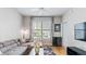 Neutral living room featuring a modern sofa, hardwood floors, and a view from large windows at 10 Perimeter Summit Ne Blvd # 1204, Brookhaven, GA 30319
