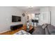 Bright living room with gray sofa, modern TV console, and breakfast bar seating at 10 Perimeter Summit Ne Blvd # 1204, Brookhaven, GA 30319