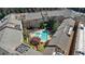 Aerial view of a community pool with lounge chairs, mature landscaping and plenty of shade at 10 Perimeter Summit Ne Blvd # 1204, Brookhaven, GA 30319