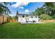 Wide backyard view with green lawn, new fence, patio with seating, perfect for outdoor gatherings at 1048 Pinehurst Se Dr, Smyrna, GA 30080