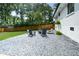 Landscaped backyard with a pea gravel patio, stylish seating, and a privacy fence at 1048 Pinehurst Se Dr, Smyrna, GA 30080