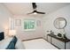 Sunlit bedroom featuring modern décor, sleek ceiling fan, and an open doorway at 1048 Pinehurst Se Dr, Smyrna, GA 30080