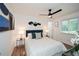 Bright bedroom with stylish decor, a ceiling fan, and a large window overlooking the yard at 1048 Pinehurst Se Dr, Smyrna, GA 30080