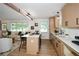 Bright and airy kitchen featuring an island with seating, modern appliances, and open-concept design to the living room at 1048 Pinehurst Se Dr, Smyrna, GA 30080