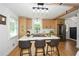 Well-lit kitchen features stainless steel appliances, a large island with bar seating, and natural wood cabinetry at 1048 Pinehurst Se Dr, Smyrna, GA 30080