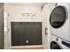 Functional laundry room with a stacked washer/dryer, stylish wall decor, and convenient storage at 1048 Pinehurst Se Dr, Smyrna, GA 30080