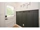 Welcoming mud room with stylish board and batten accent wall and motivational quote at 1048 Pinehurst Se Dr, Smyrna, GA 30080