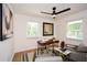 Home office with a modern desk, comfortable seating, and natural light from large windows at 1048 Pinehurst Se Dr, Smyrna, GA 30080