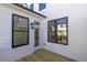 Charming back porch featuring white siding, black-framed windows, and a wood deck, creating an inviting outdoor space at 1132 Larkin Dr # 34, Buford, GA 30518