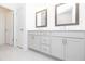 Well-appointed bathroom featuring double sinks, quartz countertops, modern fixtures, and tiled floors for a clean aesthetic at 1132 Larkin Dr # 34, Buford, GA 30518