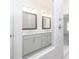 Bright and modern bathroom boasts double sinks, quartz countertops, and a glass-enclosed shower, enhancing the luxurious feel at 1132 Larkin Dr # 34, Buford, GA 30518