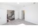 Carpeted bedroom showcasing a view of the staircase, white walls, and ample natural light at 1132 Larkin Dr # 34, Buford, GA 30518