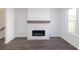 Stone fireplace with hardwood flooring, modern look with natural light from side window at 1132 Larkin Dr # 34, Buford, GA 30518
