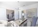 Bright home office featuring a modern desk, chair, stylish light fixture, and view of staircase at 1132 Larkin Dr # 34, Buford, GA 30518