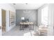Bright home office featuring a modern desk, chair, stylish light fixture, and decorative accent wall at 1132 Larkin Dr # 34, Buford, GA 30518