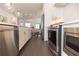 A modern kitchen featuring an island with stainless steel appliances and dark hardwood floors at 1132 Larkin Dr # 34, Buford, GA 30518