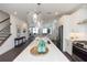 Spacious kitchen with stainless steel appliances, a large island, pendant lighting, and seamless flow to the living area at 1132 Larkin Dr # 34, Buford, GA 30518