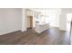 Open-concept kitchen showcasing a center island, stainless steel appliances, and hardwood flooring at 1132 Larkin Dr # 34, Buford, GA 30518