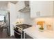 A modern kitchen features stainless appliances, white cabinets and tile backsplash at 1132 Larkin Dr # 34, Buford, GA 30518