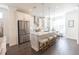 Contemporary open-concept kitchen with stainless steel appliances, ample counter space, and a large island at 1132 Larkin Dr # 34, Buford, GA 30518