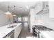 Kitchen with stainless steel appliances, island and views into the living room with fireplace at 1132 Larkin Dr # 34, Buford, GA 30518