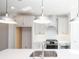 Kitchen with a kitchen island featuring a stainless steel sink, stainless steel appliances and pendant lights at 1132 Larkin Dr # 34, Buford, GA 30518