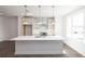 Bright kitchen with stainless steel pendant lights, large island and stainless steel appliances at 1132 Larkin Dr # 34, Buford, GA 30518