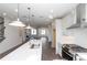 Open-concept kitchen featuring a white island and stainless steel appliances with view into the living room at 1132 Larkin Dr # 34, Buford, GA 30518