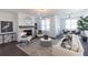 Bright living room featuring a fireplace, modern lighting, and neutral decor at 1132 Larkin Dr # 34, Buford, GA 30518