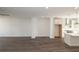Spacious living room featuring dark wood floors and bright white walls leading into the kitchen at 1132 Larkin Dr # 34, Buford, GA 30518