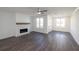 A fireplace with stone surround enhances this living room with hardwood flooring at 1132 Larkin Dr # 34, Buford, GA 30518
