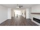 Open-concept living room with hardwood floors and modern fireplace; kitchen in background at 1132 Larkin Dr # 34, Buford, GA 30518