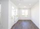 Sun-filled living room with hardwood floors and access to outdoor space at 1132 Larkin Dr # 34, Buford, GA 30518
