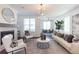Bright, open living room features a stone fireplace, modern lighting, and neutral decor at 1132 Larkin Dr # 34, Buford, GA 30518